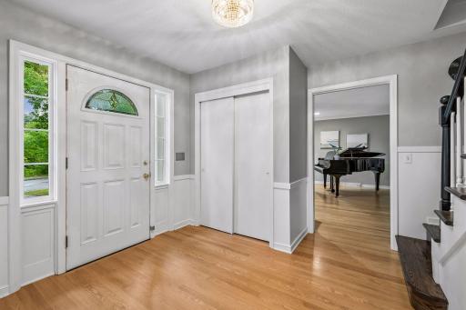 Welcome guests into the large front foyer with coat closet