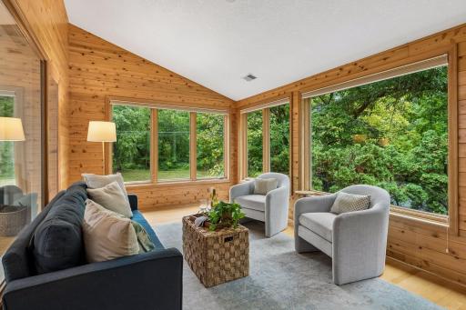 Gorgeous sun room overlooks front of home and offers unimpeded view of Minnehaha Creek