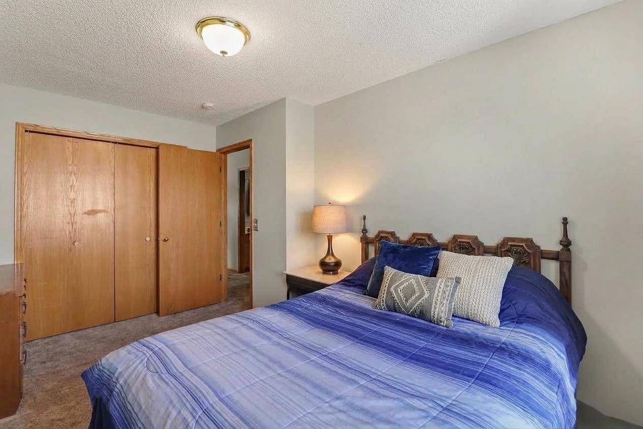 Second main-level bedroom with closet storage.