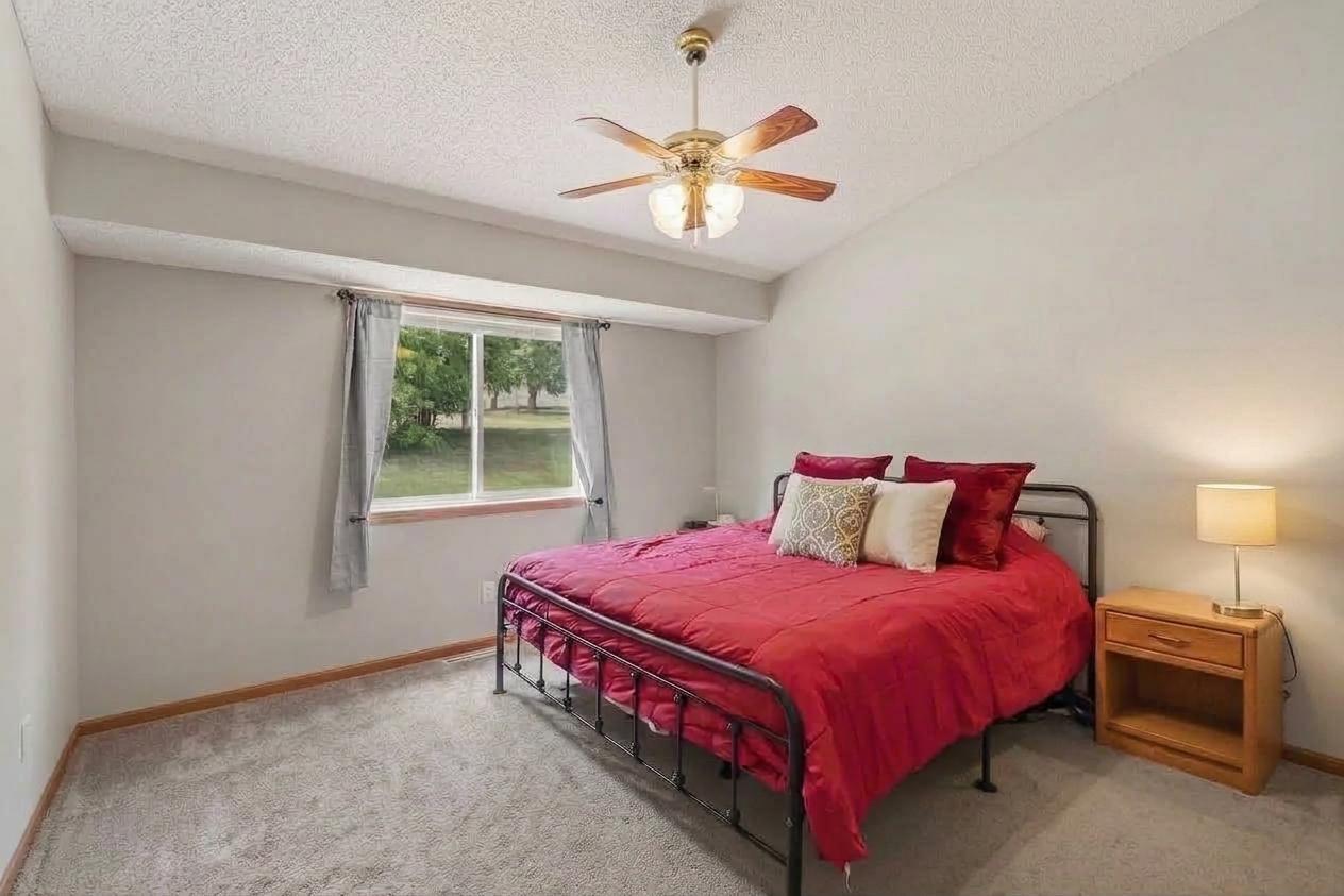 Vaulted primary bedroom with two closets and walk-through access to the main-level full bath.