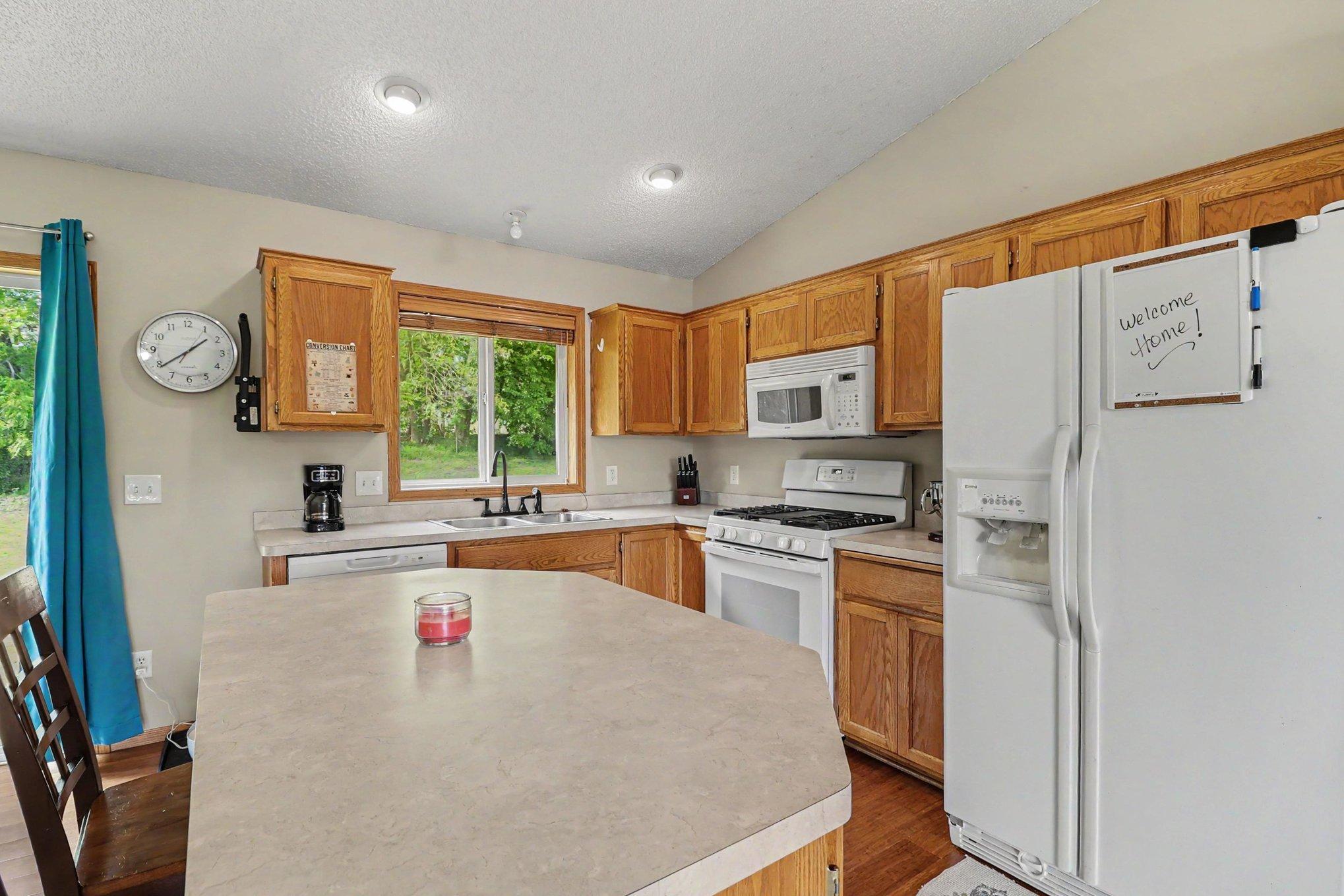 Kitchen with island and open sightlines to the adjoining dining and living spaces.