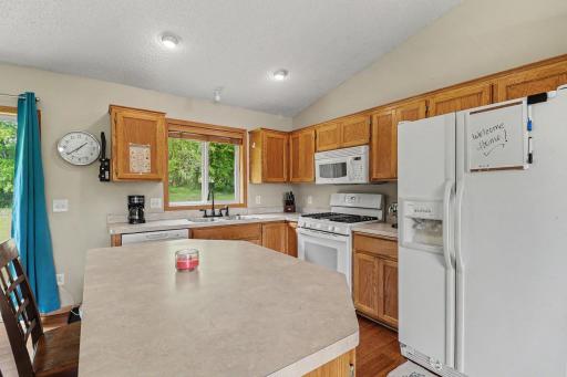 Kitchen with island and open sightlines to the adjoining dining and living spaces.