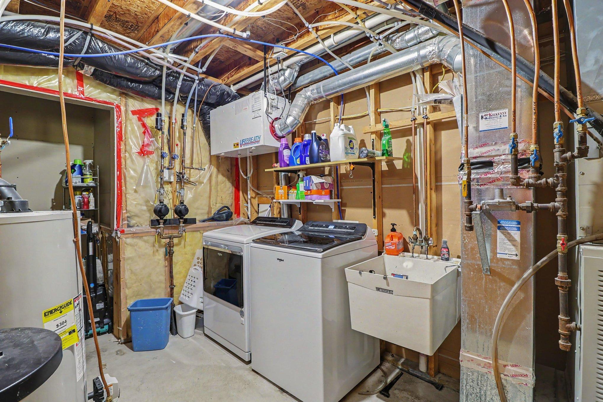 Lower-level laundry area with new washer and dryer.