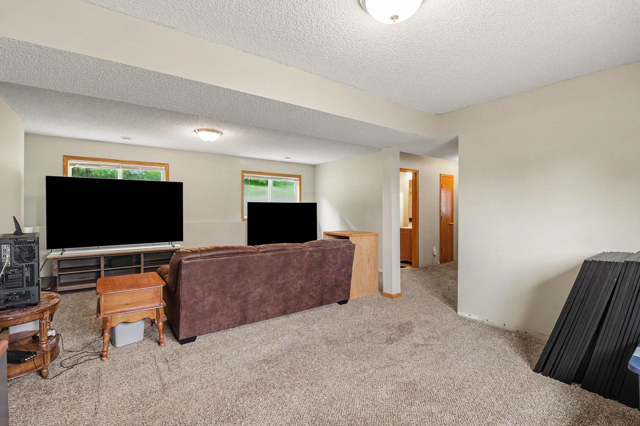 Finished lower-level family room with flexible space for lounging, hobbies, or media.