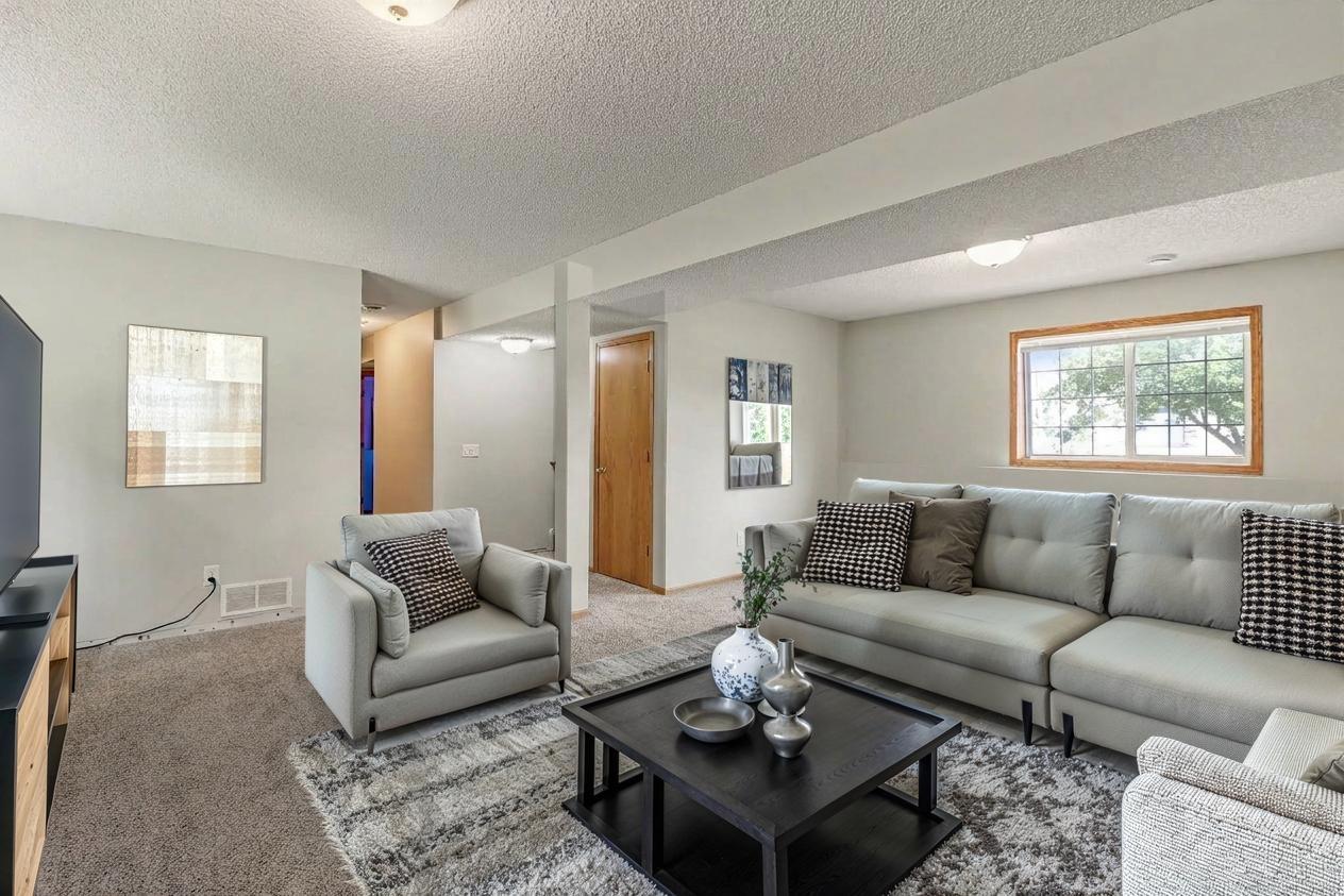 Spacious lower level family Room (virtually staged to show potential layout).jpg