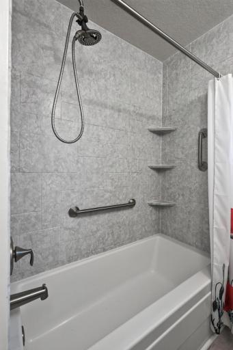 a view of the main level bahtroom shower/tub combination