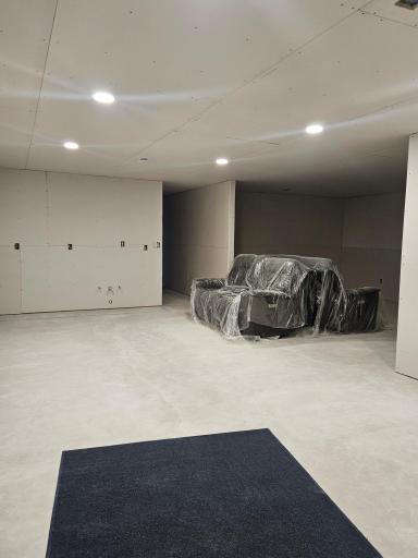 Large open room with rough in plumbing for a wet bar