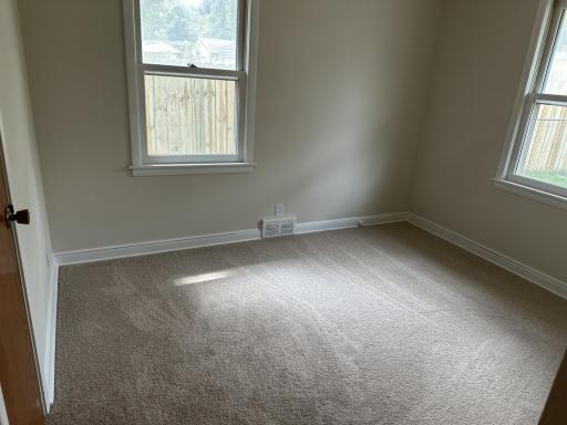 1 of 3 main floor bedrooms, with overhead ceiling fans, fresh paint and new carpet.