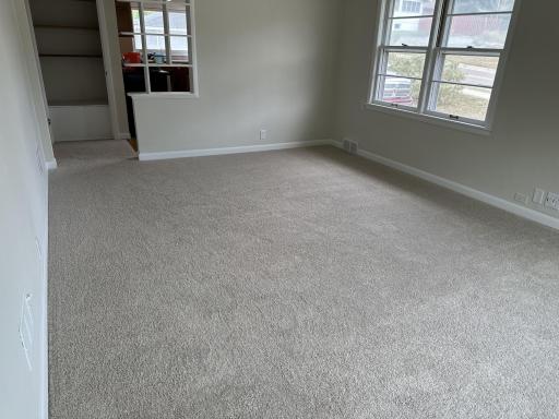 Main floor living room fresh paint and new carpet.