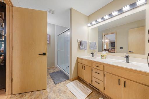 Main level 3/4 bathroom with dual-vanity and walk-in sower