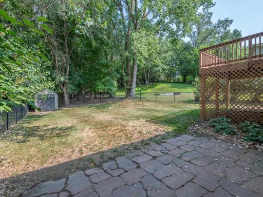 Garage service door leads to a paver patio & a sprawling, level, fenced backyard!