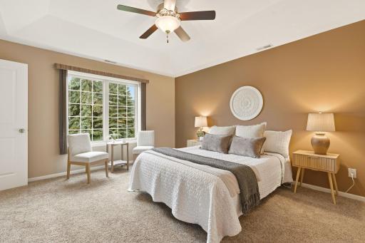 Primary bedroom with large windows, walk in closet, full bath