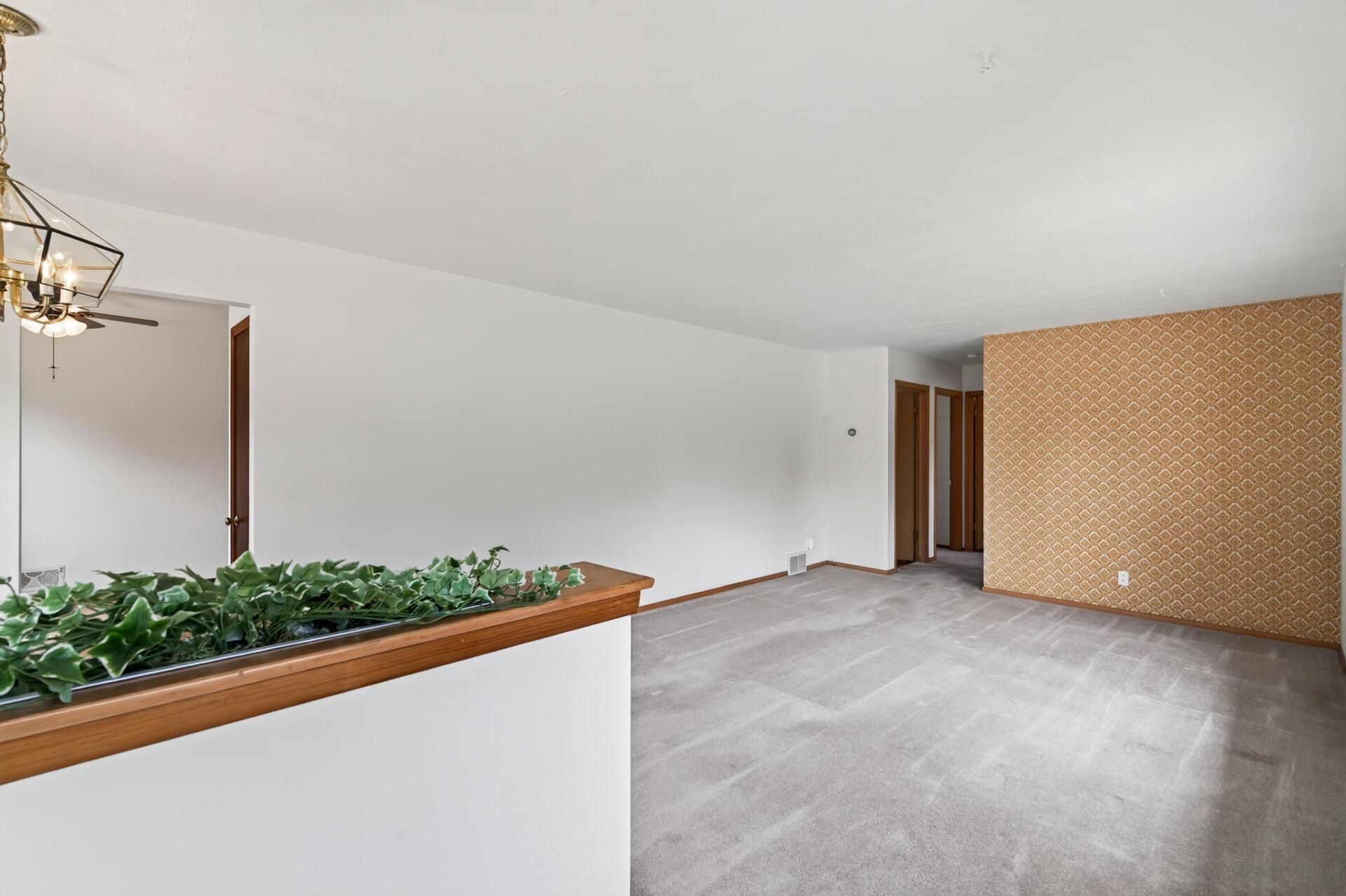 From the front door. Notice the mid-century "pony wall", and the vintage wallpaper accent wall.