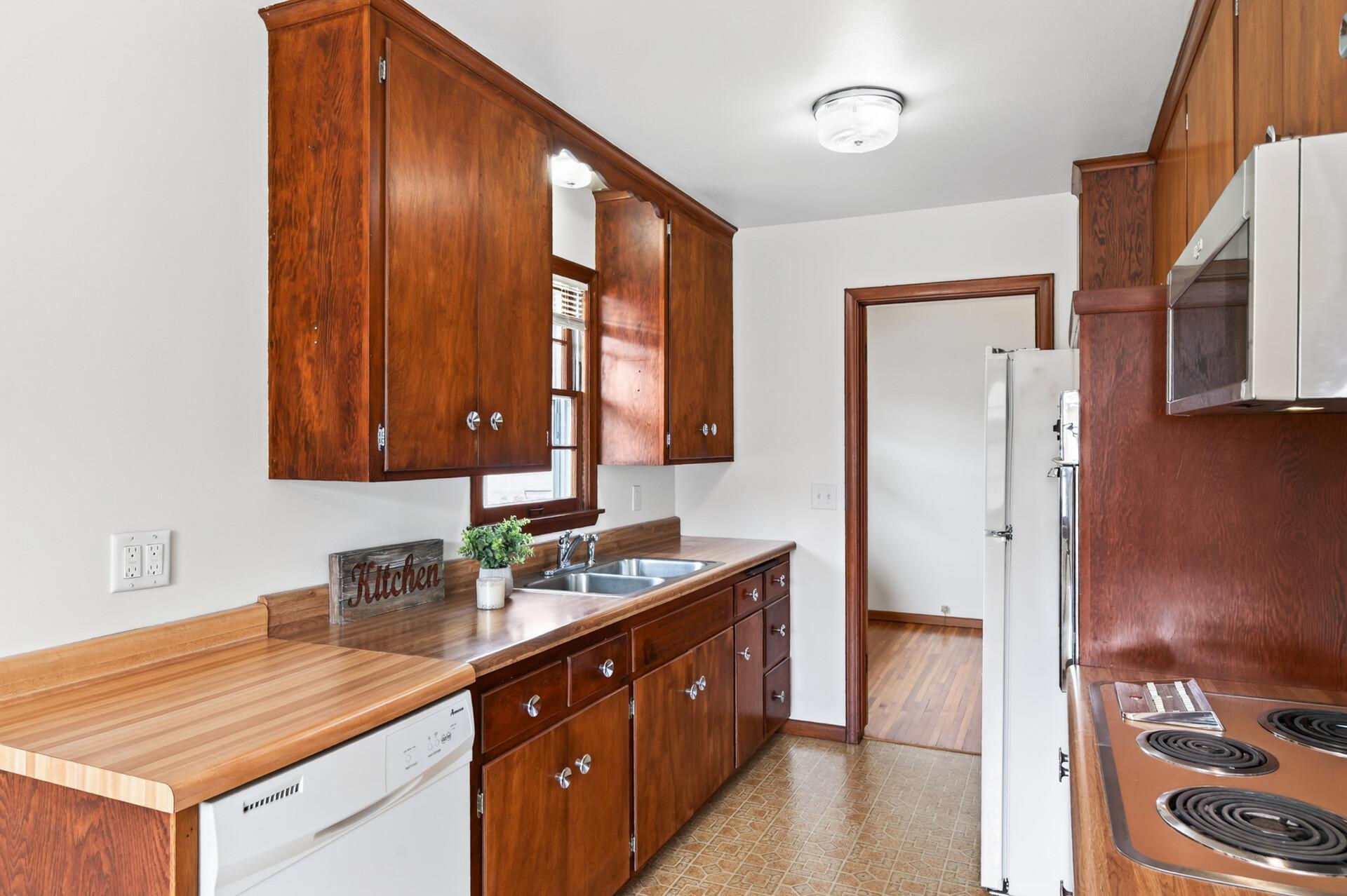 Kitchen with added countertop and built-in dishwasher. Vintage and immmaculate. Yes, the appliances are original and all in working order!