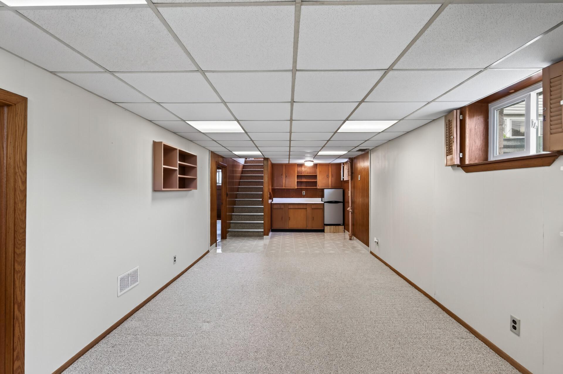 Basement family room with bar. Refrigerator stays.
