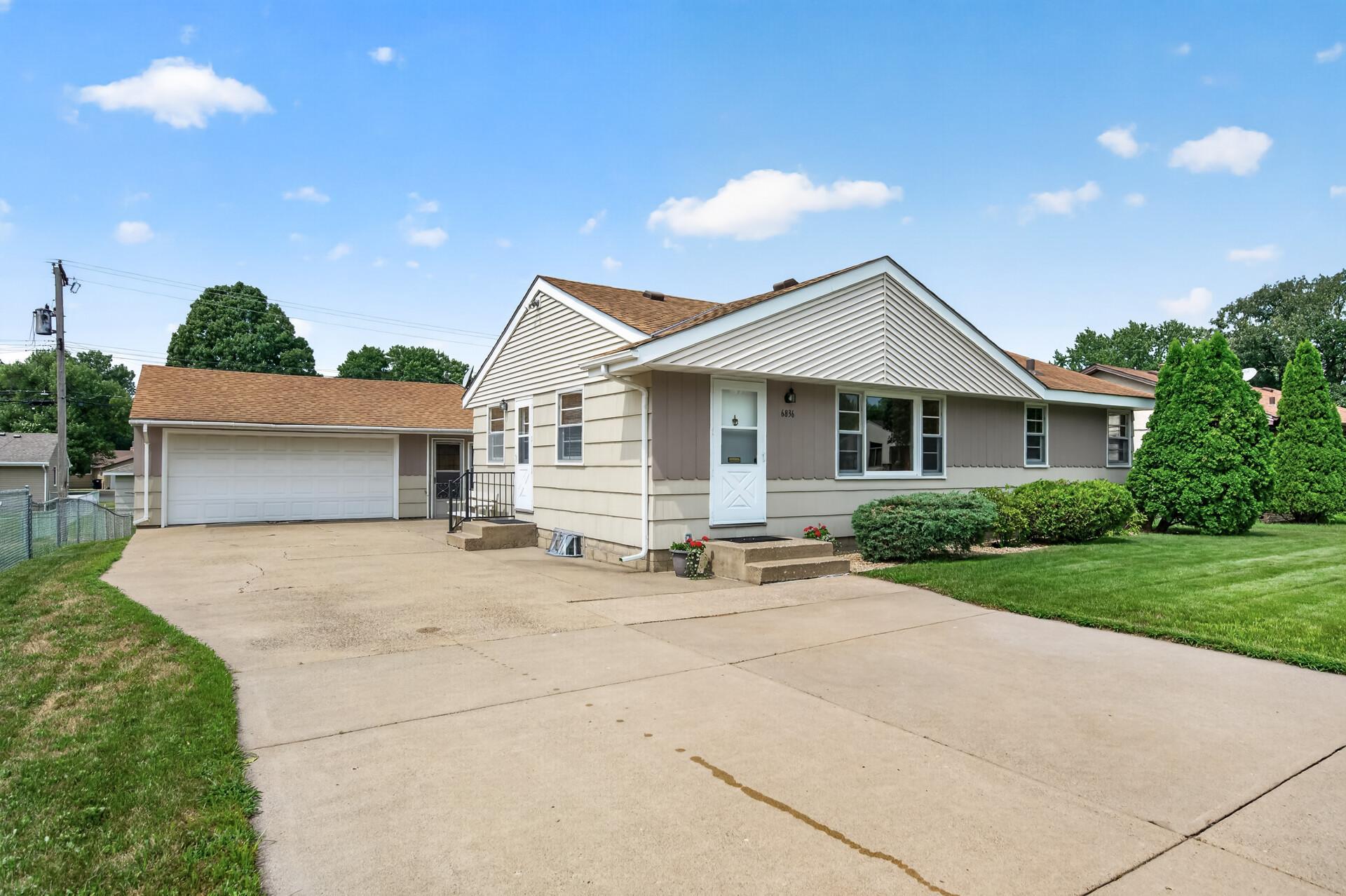 Extra large 2 car garge with workshop and attached screen porch! Extra wide concrete driveway.
