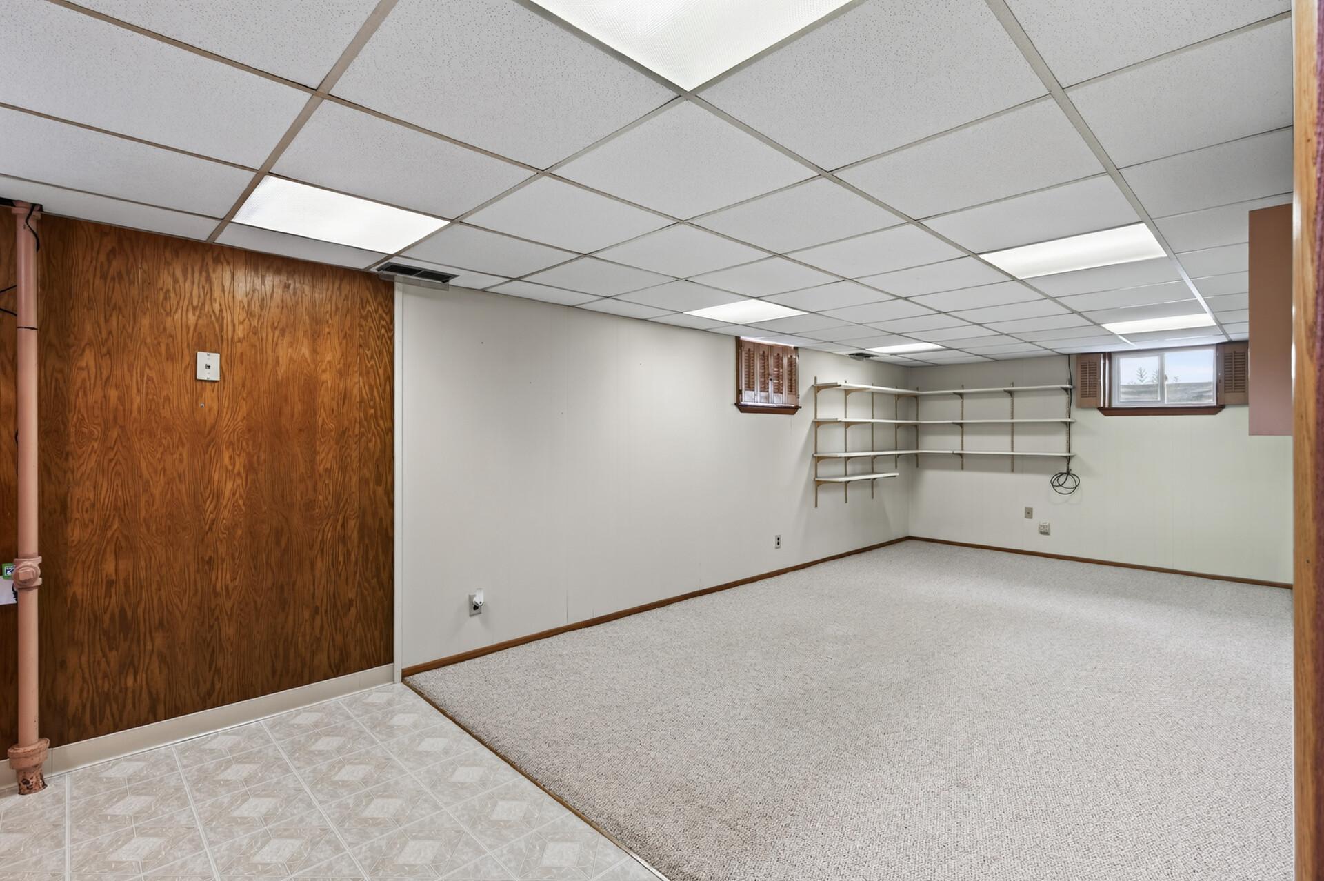Lower level living room and vinyl floor is to the bar area