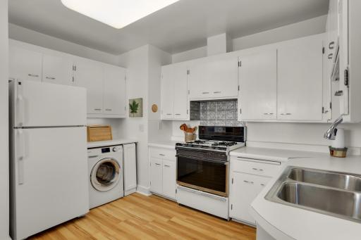 The bright, spacious kitchen includes lots of cabinetry and a great layout for cooking