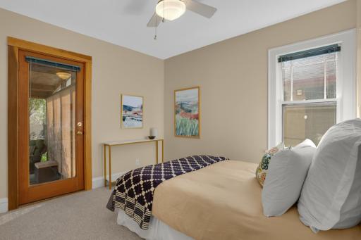 2nd bedroom on the main level has a door leading out to the screened porch in the backyard