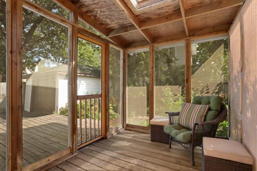 Enjoy relaxing in this fantastic screened porch that is a private oasis in the lushly landscaped backyard