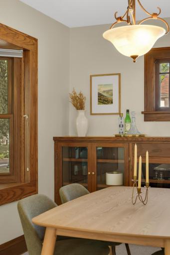 The dining room features a large built-in cabinet with glass doors