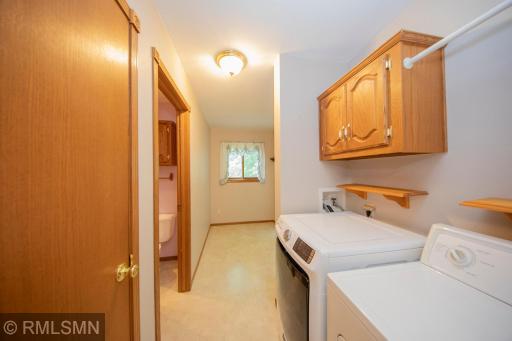 Main floor laundry with huge bonus area for coats or miscellanous storage, opens to the bath, deck and even kitchen storage.