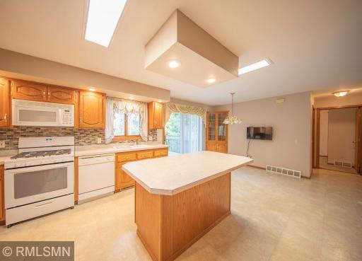 The kitchen island is well lit for creating gastronomical delights while others sit and enjoy conversations with the cook!
