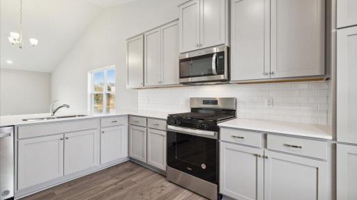 Stainless modern appliances. Photo is of similar home. Colors and options may vary. Ask Sales Agent for details.