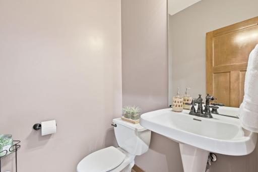 The main-level 1/4 bath is located just steps from the garage entry, laundry room, and drop-zone mudroom.