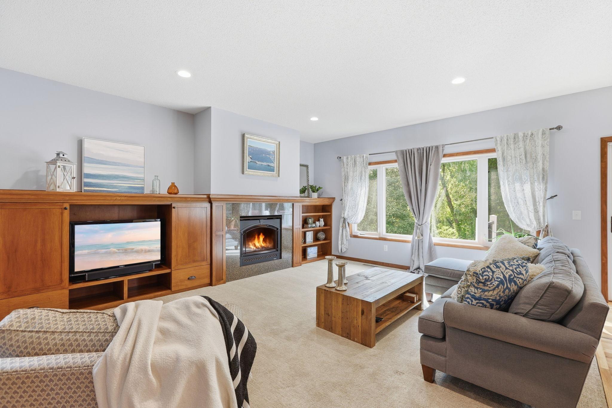 Built-in bookshelves surround the fireplace in the sunlight main-level living room.