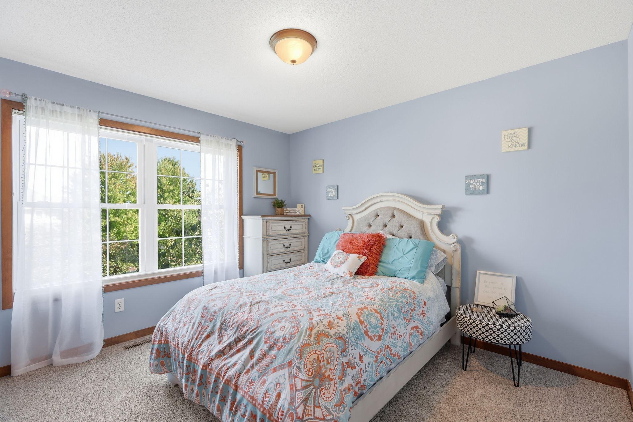 The second upper level bedroom overlooks the front yard and a beautiful pink tree in the Spring and Summer.