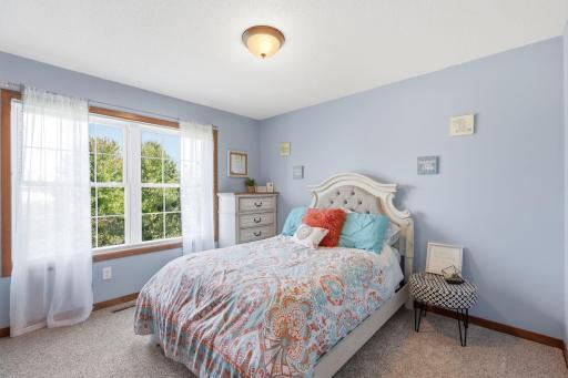 The second upper level bedroom overlooks the front yard and a beautiful pink tree in the Spring and Summer.
