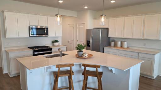 Expansive quartz island with seating (Actual home - furniture not included)