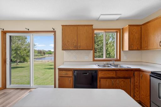 Welcoming eat-in kitchen offers generous cabinet storage, abundant natural light, and easy access to the backyard through the sliding patio door.