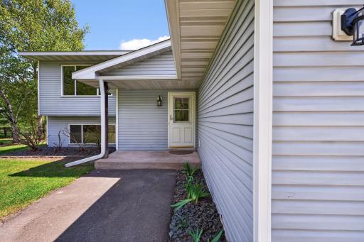 Welcoming covered front entry with low-maintenance exterior and convenient attached garage.