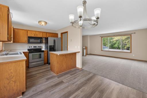 Spacious kitchen with peninsula seating area, generous cabinetry, and an open layout connecting seamlessly to the dining and living spaces.
