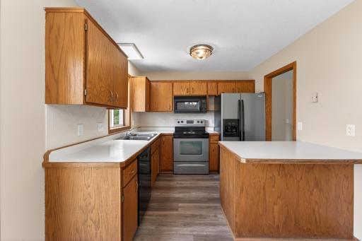 Spacious kitchen with peninsula seating area, generous cabinetry, and an open layout connecting seamlessly to the dining and living spaces.