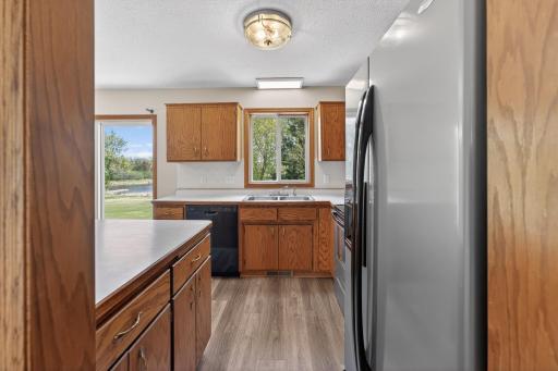 Enjoy preparing meals while overlooking the scenic backyard and water views from the kitchen and dining area.