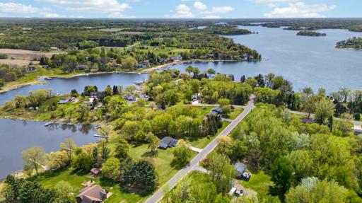 Beautiful aerial views showcase the expansive lot, wooded privacy, lake access, and exceptional location within the scenic Chisago Lakes region.