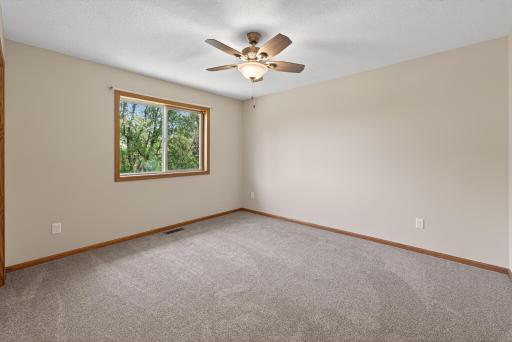 Upper-level bedroom with ceiling fan, double closet, and calming neutral color palette ready for your personal touch.