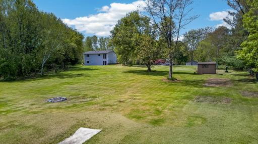 Beautiful waterfront setting surrounded by mature trees, open green space, and scenic natural views in every direction.