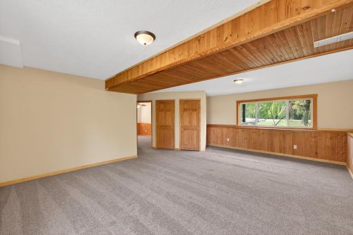 Huge lower-level family room offers incredible space for entertaining, recreation, movie nights, or future game room possibilities.