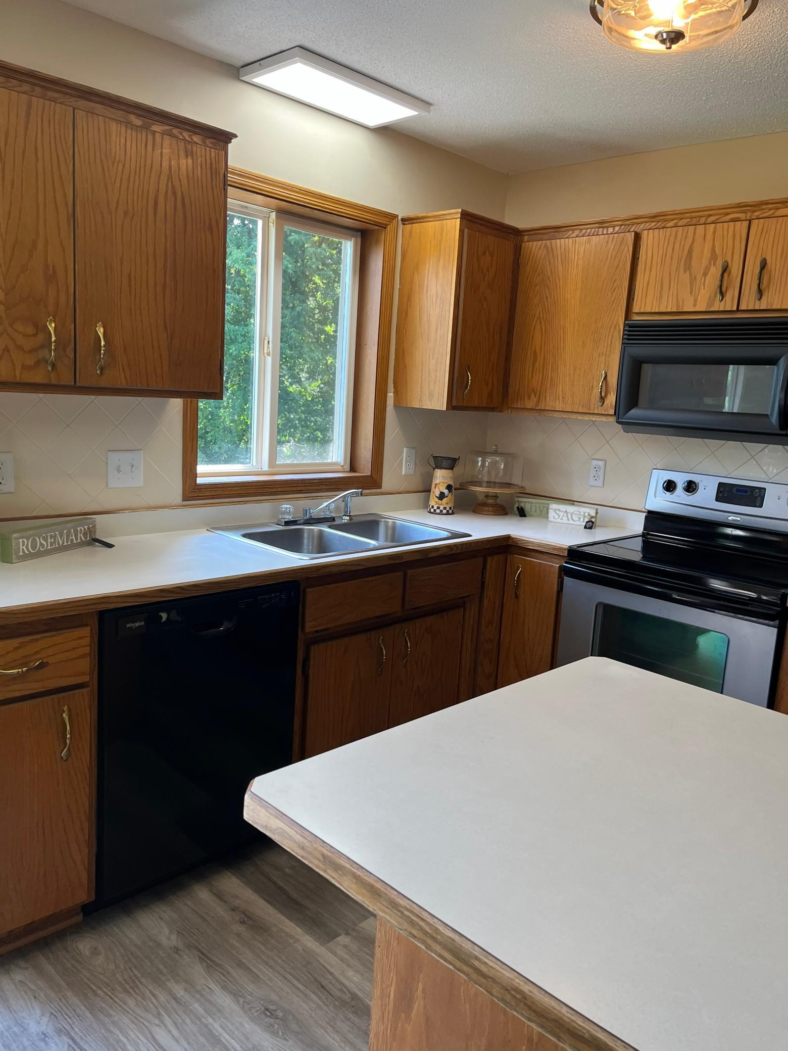 Enjoy preparing meals while overlooking the scenic backyard and water views from the kitchen and dining area.