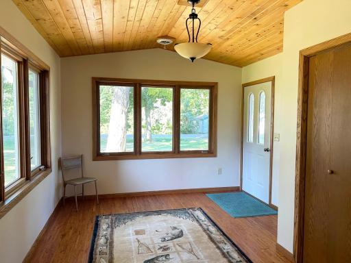 A look at the entryway / mudroom, with hardwood floors and vaulted tongue & groove ceiling.