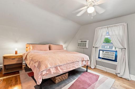 Comfortable bedroom with hardwood floors