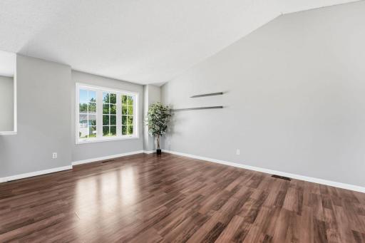 Soaring vaulted ceilings and large windows enhance this wonderful room.