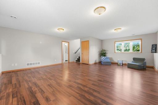Step inside to an open and inviting floor plan, where gleaming laminate wood floors bring warmth and durability.