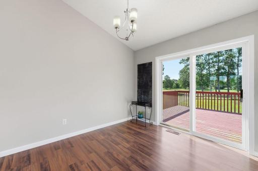 Adjacent to the kitchen, a sun-filled dining area creates a warm and inviting atmosphere, with a sliding patio door leading to the deck for easy outdoor entertaining.