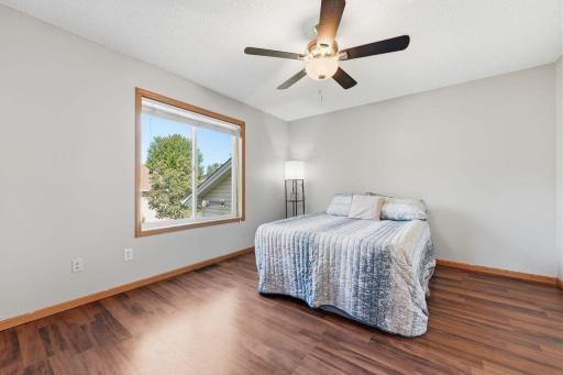 The generous sized Primary Bedroom highlights a ceiling light/fan combo and large window, with plenty of room for furniture.