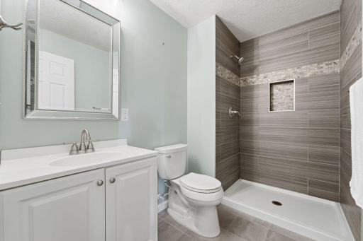 The 3/4 LL bathroom features a gorgeous tiled shower stall with an updated look.